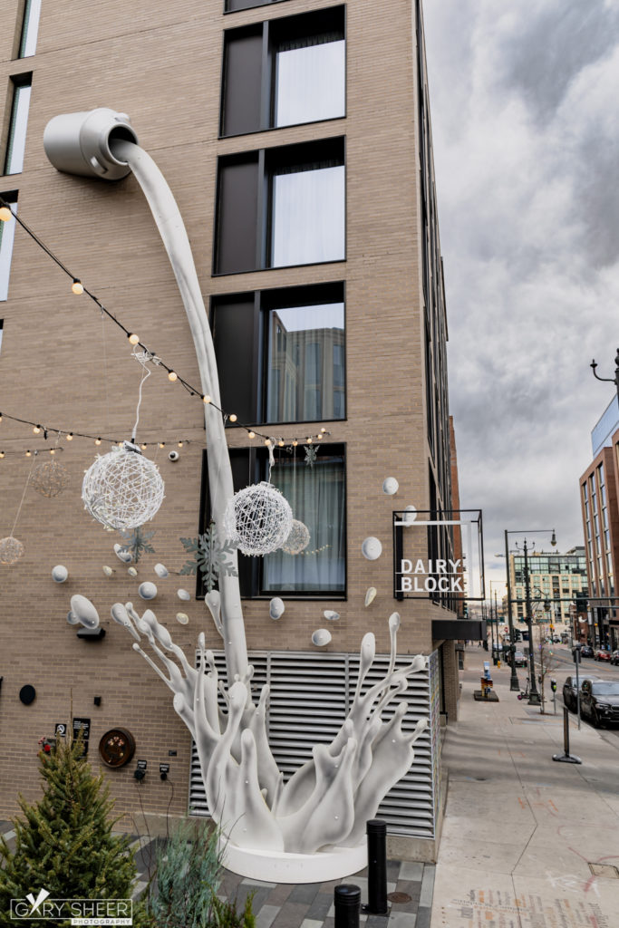 Portrait of outdoor art milk jug splashing milk onto the ground outside the Dairy Block in Denver Colorado © Gary Sheer Photography