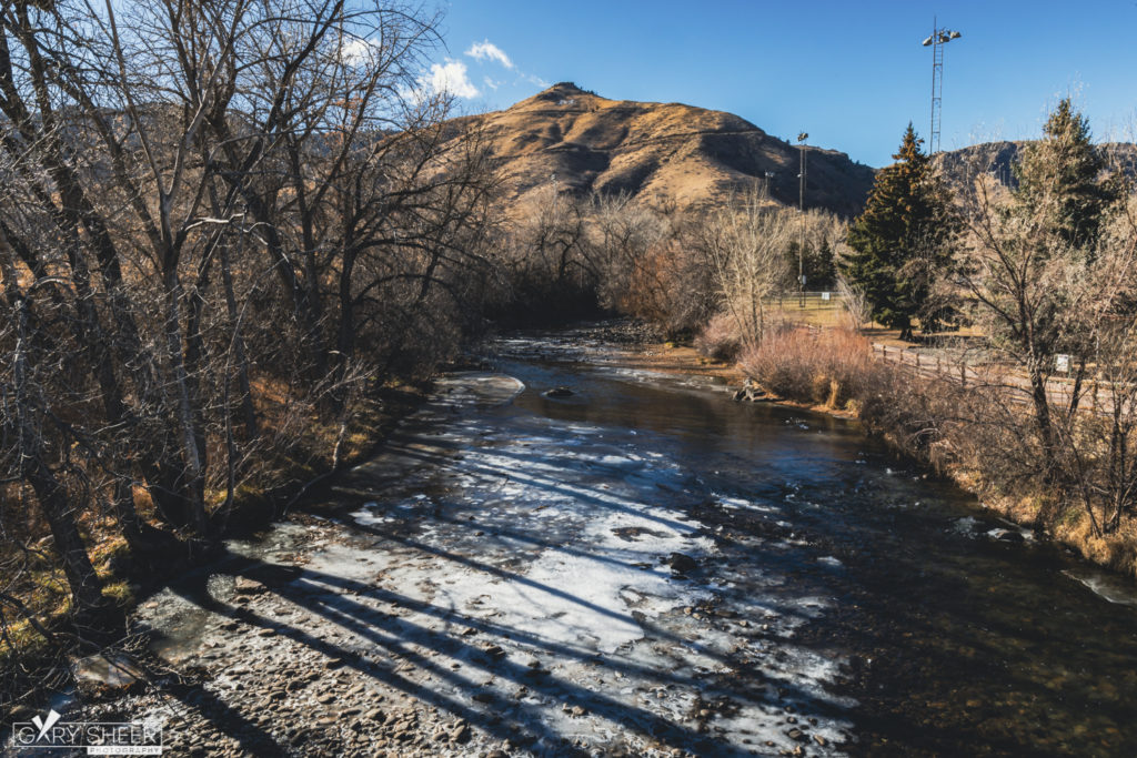 Landscape view of partially frozen river with mountain in the background at Golden History Park © Gary Sheer Photography